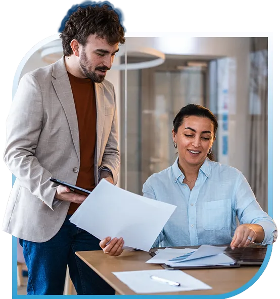 Man and Woman Collaborating Over Paperwork
